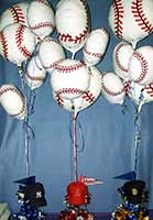 Baseball balloons float above hat and pennant centerpieces for baseball themed mitzvah