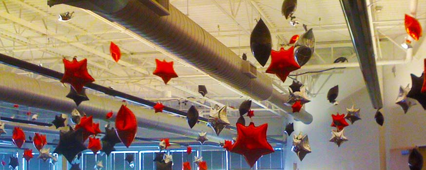 This ceiling is covered with a scattering of 30 inch mylar stars creating an outdoor illusion.