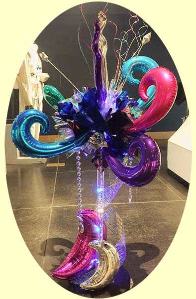 A four foot tall chrome mylar sculpture serves as an area and buffet centrpiece decoration