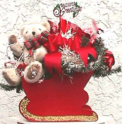 A bear rides in a tiny Santa's sleigh for this centerepiece