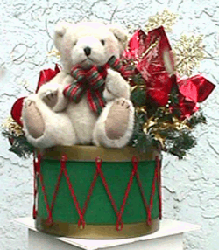 This centerpiece consists of a ten inch diameter toy drum topped by a furry bear and HOLIDAY ORNAMENTS