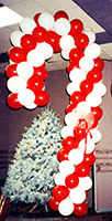 Balloonatics eight foot tall candy cane balloon sculpture speaks of both sweets and Christmas cheer