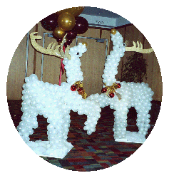 Five foot tall sculptures of two reindeer made of pearl white balloons with gold foamcor antlers to serve as an entrance decoration for a holiday party.