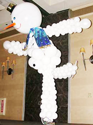 This six foot tall balloon sculpture snowman is joyfully skating for skating theme holiday party.