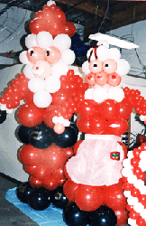 Six foot tall balloon figure sculptures of Mr. and Mrs. Claus to serve as area theme props for a Christmas theme holiday party.