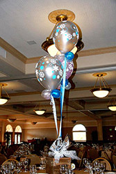 This bouquet centerpiece of three silver latex balloons adorned with snowflakes communicates a theme of simple elegance.