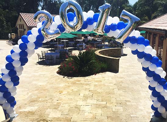 This spiral packed arch is the main decor piece for a class of 2017 pool party.