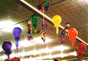 This playful balloon arch suspending an inverted clown was a decoration at a trade show