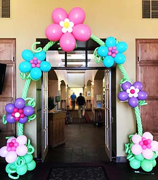A playful entrance arch created of balloon fantasy flowers on a balloon vine.