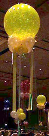 30 inch yellow translucent bubble floating 8' above the venue floor with matching decorative collar and streamers