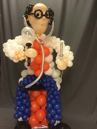 This six foot tall balloon character sculpture of a smiling physician complete with stethoscope ready to care for all