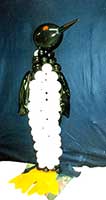 A 4 foot tall sculpture of a penguin created from black and white balloons as a buffet table centerpiece