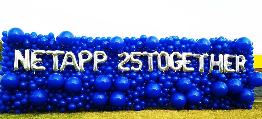 An 30 foot long balloon sign wall of varing size blue balloons giving an organic appearnce.