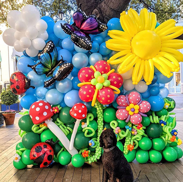 An 20 foot organic style balloon yard sign to announce a gender reveal event.