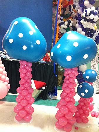 Our five foot tall balloon sculpture Magic Mushrooms are created with rose colored stems topped by double-stuffed blue polka dot balloons