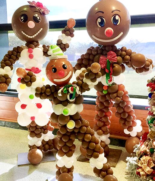 Six foot tall balloon sculptures of Mom, Pop, and Jr Gingerbread
