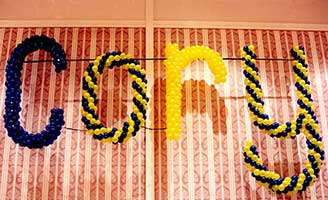 Wall name sign constructed of swirled balloons