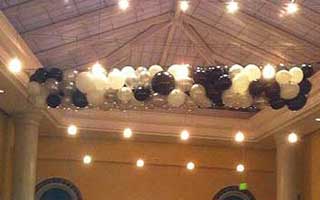 Net balloon drop of black and white colored balloons for a formal decor style event