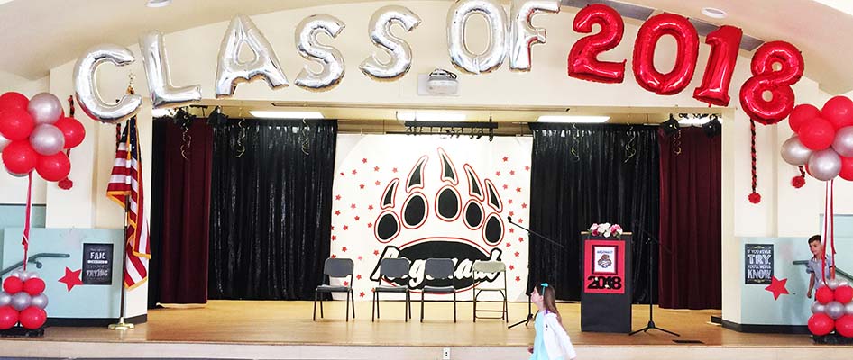 This spiral packed arch is the stage back drop decoration for a school graduation event.