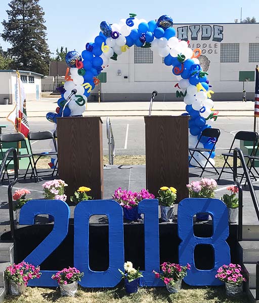 This spiral packed arch is the stage back drop decoration for a school graduation event.