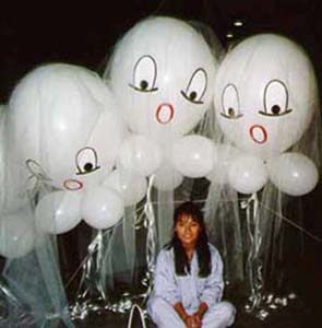 These floating white 30 inch diameter balloons are decorated with faces and covered with white ghostly gauze-like tule