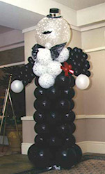 An eight foot tall formal balloon greeter figure of black and white balloons.