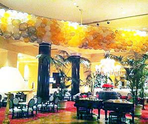 a net balloon drop of black and white balloons rigged over the dance floor in lobby of the San Jose Fairmont Hotel