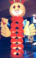 A 7 foot tall balloon column figure holding the ace of hearts serves as an area decoration for casino theme parties