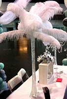 A carnival style casino table centerpiece of giant feathers
