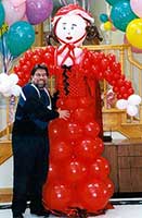 Balloon sculpture of Red Riding Hood on her way to grandmother's house