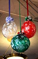 Balloon sculpture of a super size colorful holiday ornaments carries the holiday decor theme throughout this venue