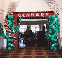 A pair of giant balloon sculpture cactus with a connecting balloon arch flanking the entrance to a western theme party