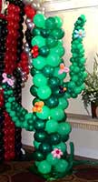 A giant balloon sculpture cactus is one of the area decorations at this western theme event