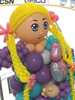 Fifteen foot tall balloon sculpture of Goldilocks with her long bright yellow braids holding a balloon bear