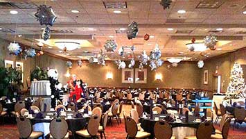 Snowflake balloons suspended throught a venue for a ceiling decoration