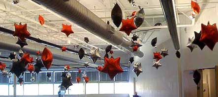 Mylar star balloons suspended throught a venue for a ceiling decoration