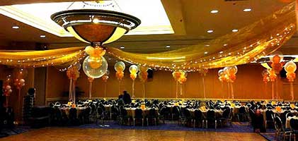 Tulle streamers lined with sparkle lights radiating out from a center balloon cluster