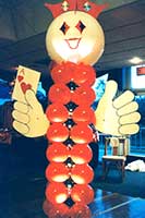 Casino greeter type columntopped by a large face balloon