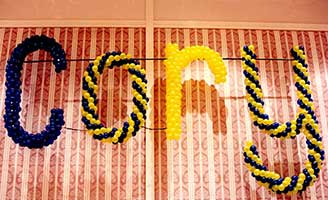 Giant name sign created in colorful twisted balloons