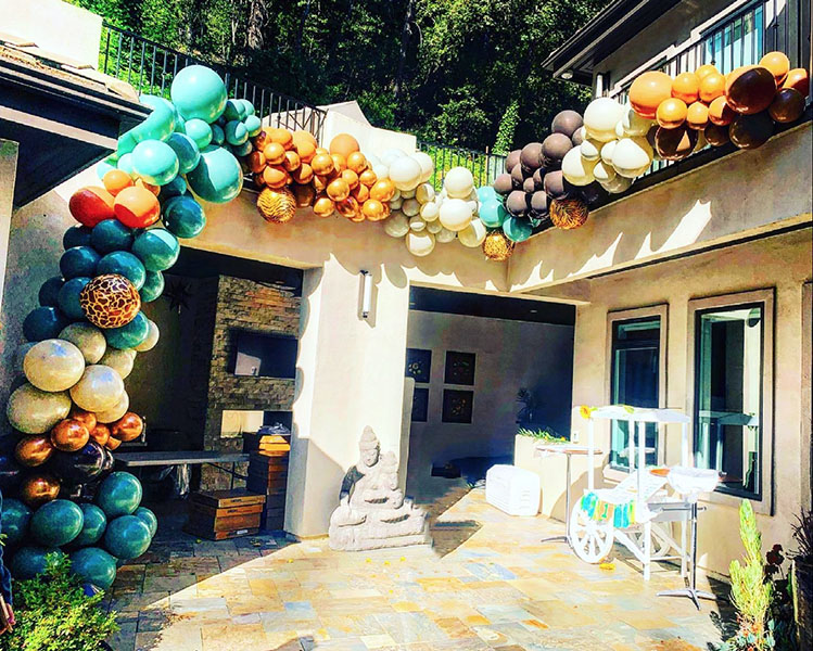 Organic style garlands decorate the walls of a courtyard