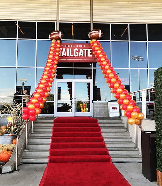 Two garlands in 49ers colors flanking the entrance to a tailgate event