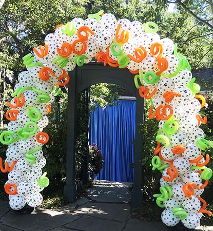 This white packed balloon arch is covered with imprinted paw prints for a pet lover party.