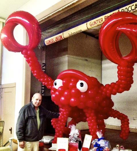 This giant 8' tall balloon sculpture of a red lobster is for a business promotion.