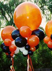 These 30 inch diameter orange balloon bubbles are created with collars of orange and black balloons to serve as area decorations visually carrying the Halloween theme throughout a venue 