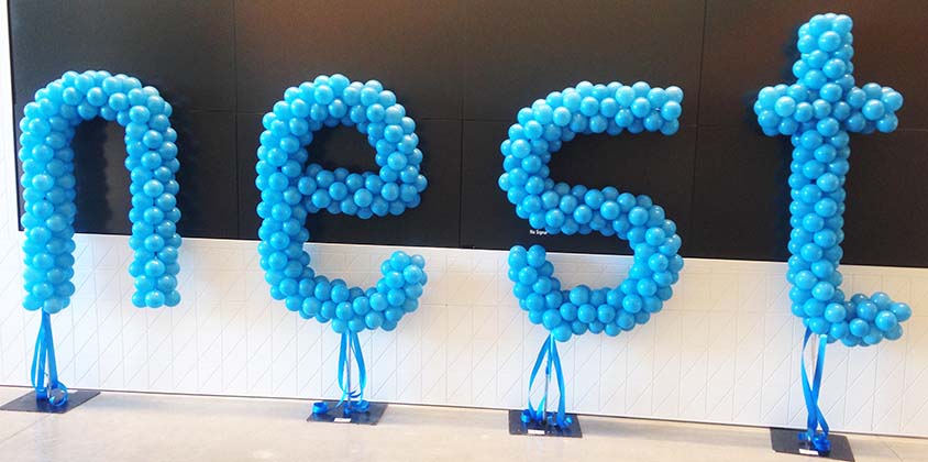 A 4 foot tall balloon logo sculpture of the NEST logo created as four individual air-filled letters for an event at NEST headquarters